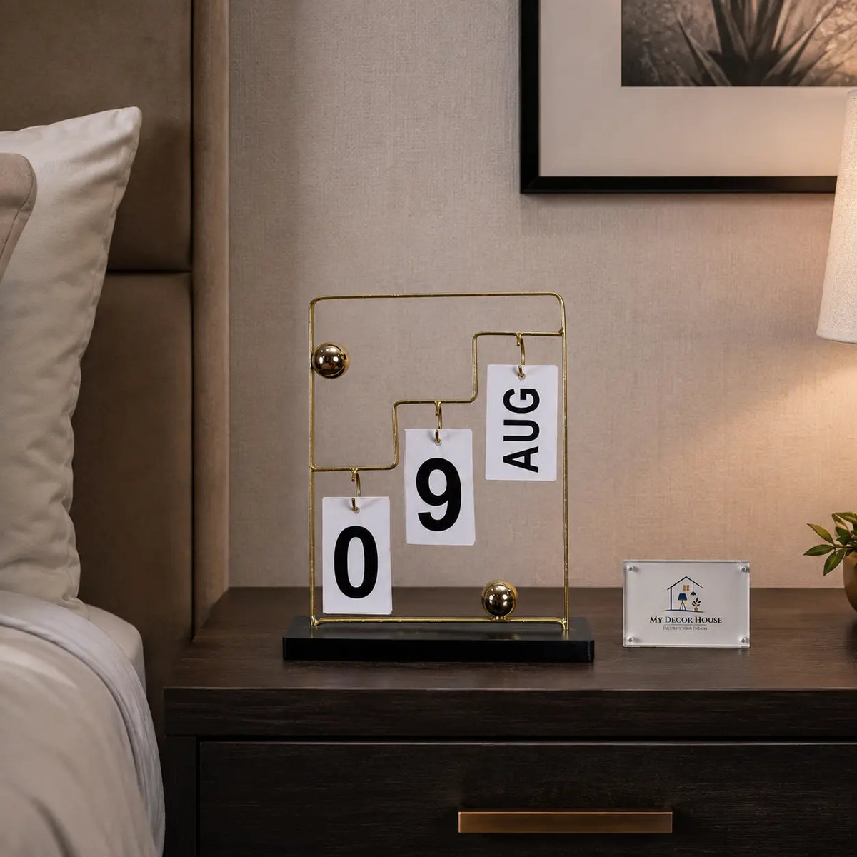 Gold-tone office desk calendar with hanging date cards